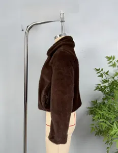 Detail view of the thick plush texture and stand collar of this dark brown faux fur jacket