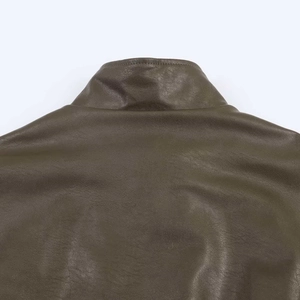Detailed macro view of olive brown faux leather texture and precise double stitching