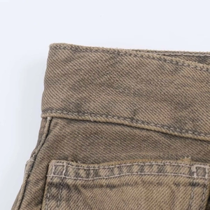 Detail shot of khaki denim high waist stitching and twill fabric texture close-up