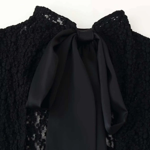 Black lace romper with high neck and elegant satin bow detail on the back view