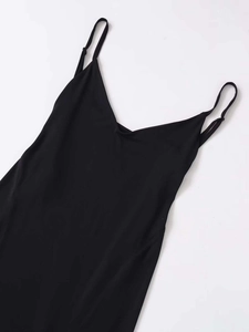Detail view of the elegant V-neckline and adjustable spaghetti straps on the black dress