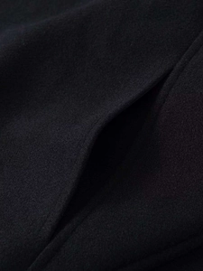 Macro detail of high-quality wool blend fabric and seamless side pocket on black jacket
