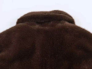 Detailed macro shot of deep chocolate faux fur texture with high gloss finish