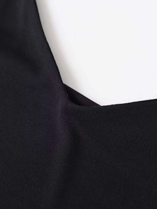 Detailed macro shot of the black V-neck neckline fabric and neat stitching craftsmanship