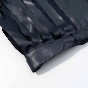 Detailed close-up of premium leather jacket with fringe tassels and high-quality stitching