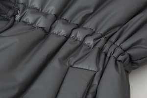 Macro detail of high-density windproof winter parka fabric with adjustable drawstring waist