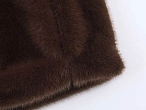 Close-up of thick coffee brown faux fur texture and neat stitching on vintage coat