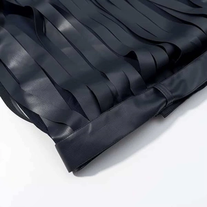 Close-up of black leather jacket with long fringe tassels and premium stitching details