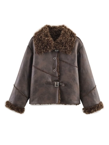 Detail of vintage brown faux leather jacket featuring plush faux fur lining and metal buckles