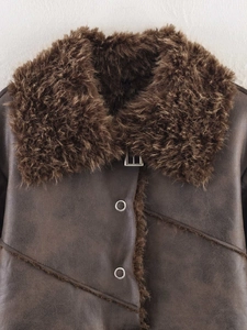 Detail view of brown faux leather shearling jacket with faux fur collar and metal buckle