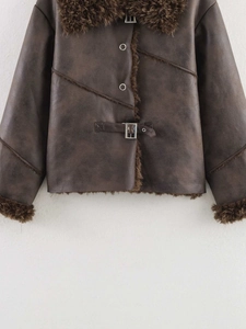 Detail of vintage brown faux leather jacket with plush shearling trim and metal buckles