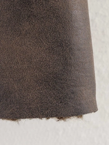 Close-up of brown suede fabric with warm plush lining on winter fashion coat