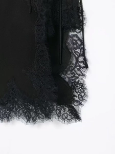 Detail shot of elegant black eyelash lace trim with floral patterns on fabric edge