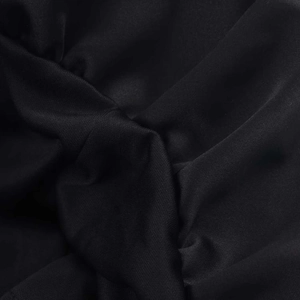 Macro detail of high-quality black textile fabric with fine grain texture and silk-like sheen