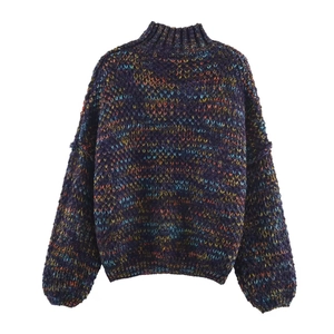 Close-up of thick chunky knit texture on oversized mock neck sweater in rainbow mix colors