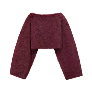 Detail of burgundy faux fur cropped jacket showing plush texture and long sleeves