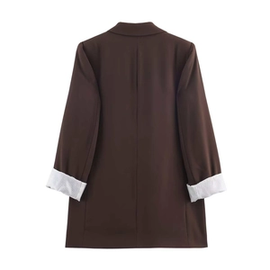 Detail view of brown blazer back with striped lining on folded cuffs in high quality