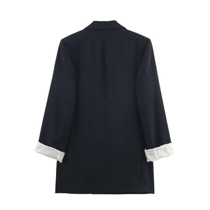 Detail of black blazer back view with striped lining visible on rolled-up cuffs