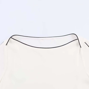 White boat neck chiffon top with minimalist black contrast piping and elegant tailoring