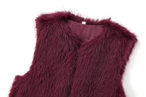 Detailed view of burgundy faux fur vest with long fibers and smooth satin inner lining