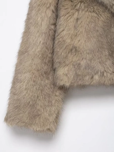 Close-up of soft faux fur texture and sleeve detail on a warm camel winter jacket