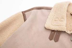 Detail of the winter jacket collar with beige suede and soft white faux fur trim