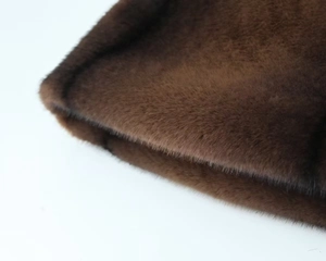Close-up of the dense dark brown faux fur fabric texture showing softness and thickness