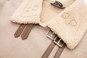 Detail of faux suede aviator jacket with shearling collar and leather buckle straps