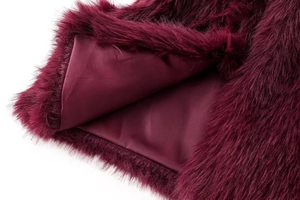 Detailed close-up of wine red faux fur texture and smooth silky inner lining