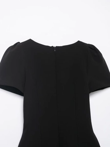 Detail view of the back collar with a hidden zipper and puffed shoulder sleeve design