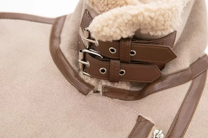 Detail of faux fur collar and brown leather buckle straps on khaki aviator jacket