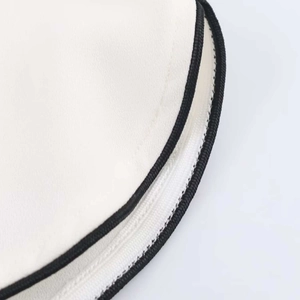 Close-up of contrast black piping on white chiffon top with high-quality zipper detail