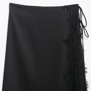 Elegant black satin skirt for women featuring delicate lace trim and side tie detail