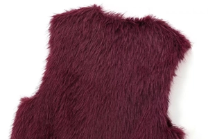 Close-up of deep purple faux fur vest showing soft texture and long hair details