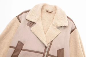 Detail of shearling aviator jacket showing wool collar, leather trim, and metal buckle