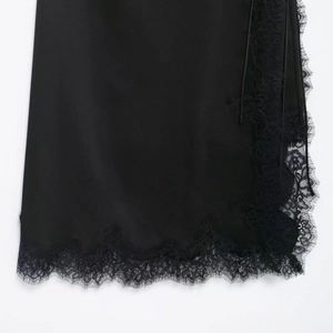 Elegant black satin skirt with delicate floral eyelash lace trim on the hemline