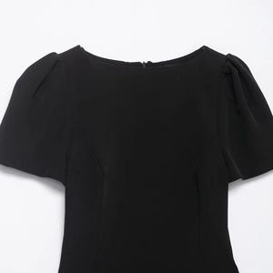 Elegant black puff sleeve dress featuring a chic boat neck and hidden back zipper
