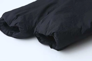 Detail of elastic cuff on casual black puffer jacket with quilted synthetic fabric