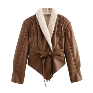 Detail of faux leather jacket featuring white shearling lining and decorative waist tie