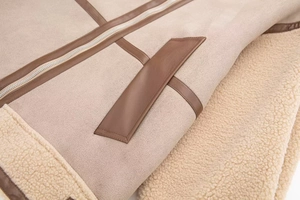 Detail of faux shearling flight jacket with beige suede and contrast leather piping