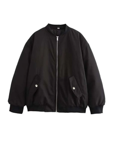 Detail of black oversized bomber jacket with silver metal snap pockets and ribbed cuffs