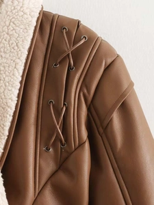 Detail of faux shearling collar and lace-up shoulder on brown leather jacket