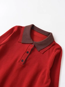 Detail of red knit POLO sweater with dark brown contrast collar and three black buttons