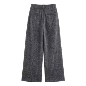 Detailed close-up of dark grey herringbone wool texture on high waist wide leg trousers
