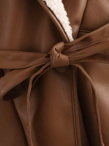 Detail of dark brown leather jacket with white sherpa lining and waist belt tie