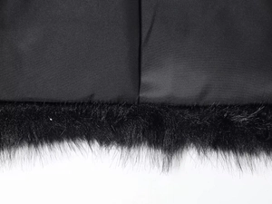 Detailed close-up of the black faux fur trim and premium inner lining texture of the jacket