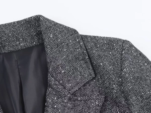 Detail shot of grey herringbone wool blazer with notch lapel and black satin lining