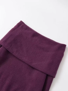 Macro view of burgundy knitted fabric texture and folded collar edge detail