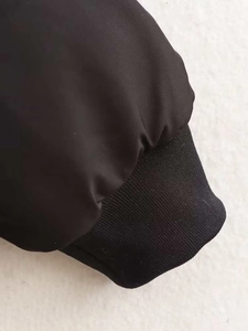 Detailed macro view of black baseball jacket cuff with elastic ribbed knitting texture