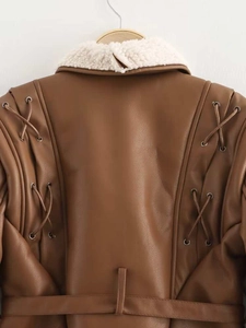 Detailed back view of brown leather biker jacket with lace-up eyelets and shearling collar